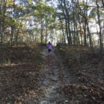 Anna running up large hill